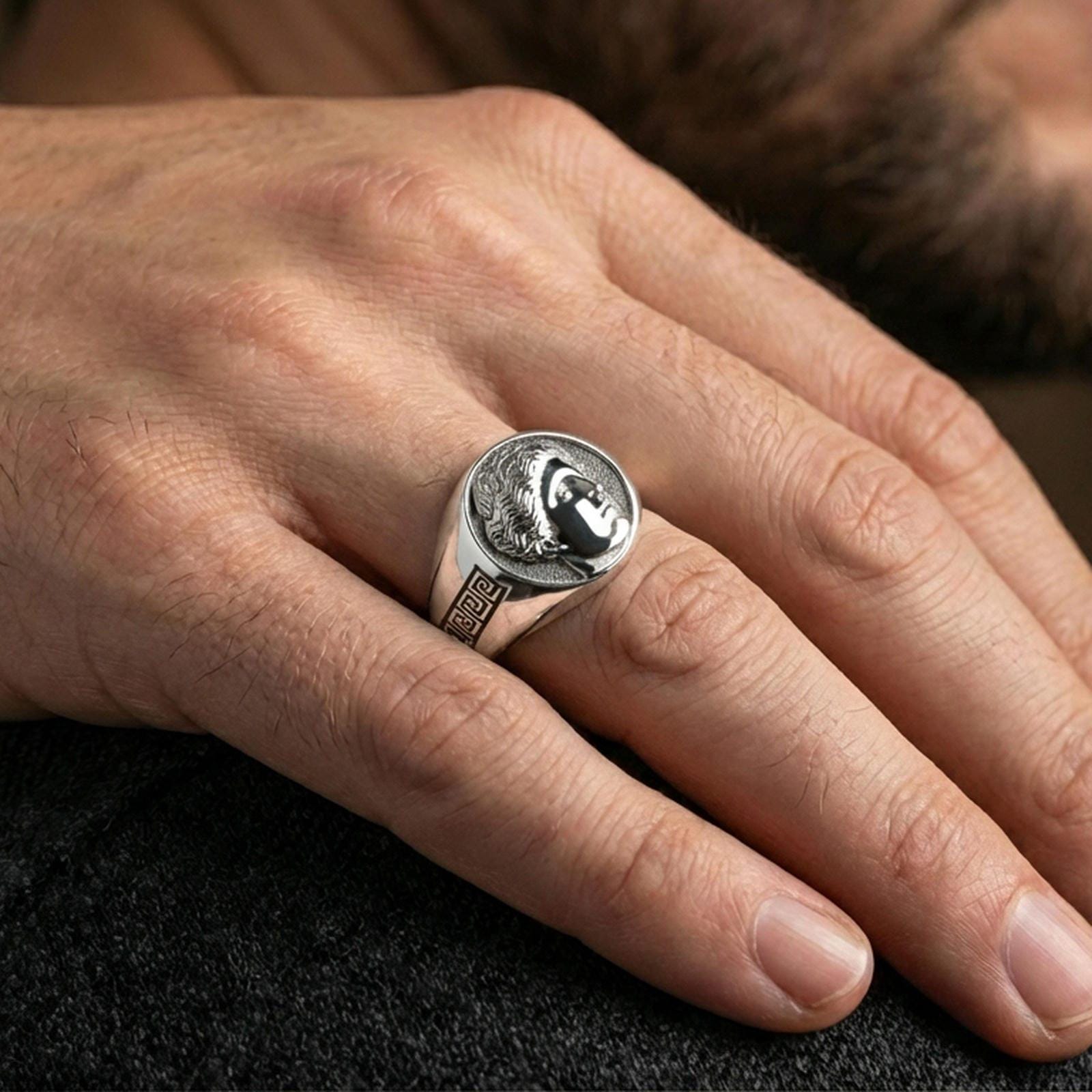 Venus Roman goddess signet ring in polished silver finish on finger, coin-inspired portrait relief and geometric side details, lifestyle wear shot