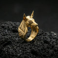 Load image into Gallery viewer, Egyptian Anubis ring in a gold plated finish on volcanic rock, Eye of Horus detail and sleek jackal head design, luxury macro jewelry image
