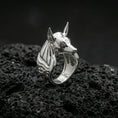 Load image into Gallery viewer, Anubis signet ring in polished silver finish on volcanic rock, sculpted jackal profile and smooth inner band, premium studio close-up
