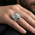 Load image into Gallery viewer, Hermes winged helmet ring in polished silver finish on finger, reflective deity portrait and feathered sides, clean lifestyle hand photo
