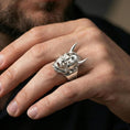 Load image into Gallery viewer, Hannya mask ring in polished silver finish on hand, reflective demon face and horn sculpting, clean lifestyle jewelry photo

