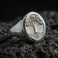 Load image into Gallery viewer, Yggdrasil Tree of Life ring in polished silver finish on volcanic rock, detailed roots and branches, premium product photo
