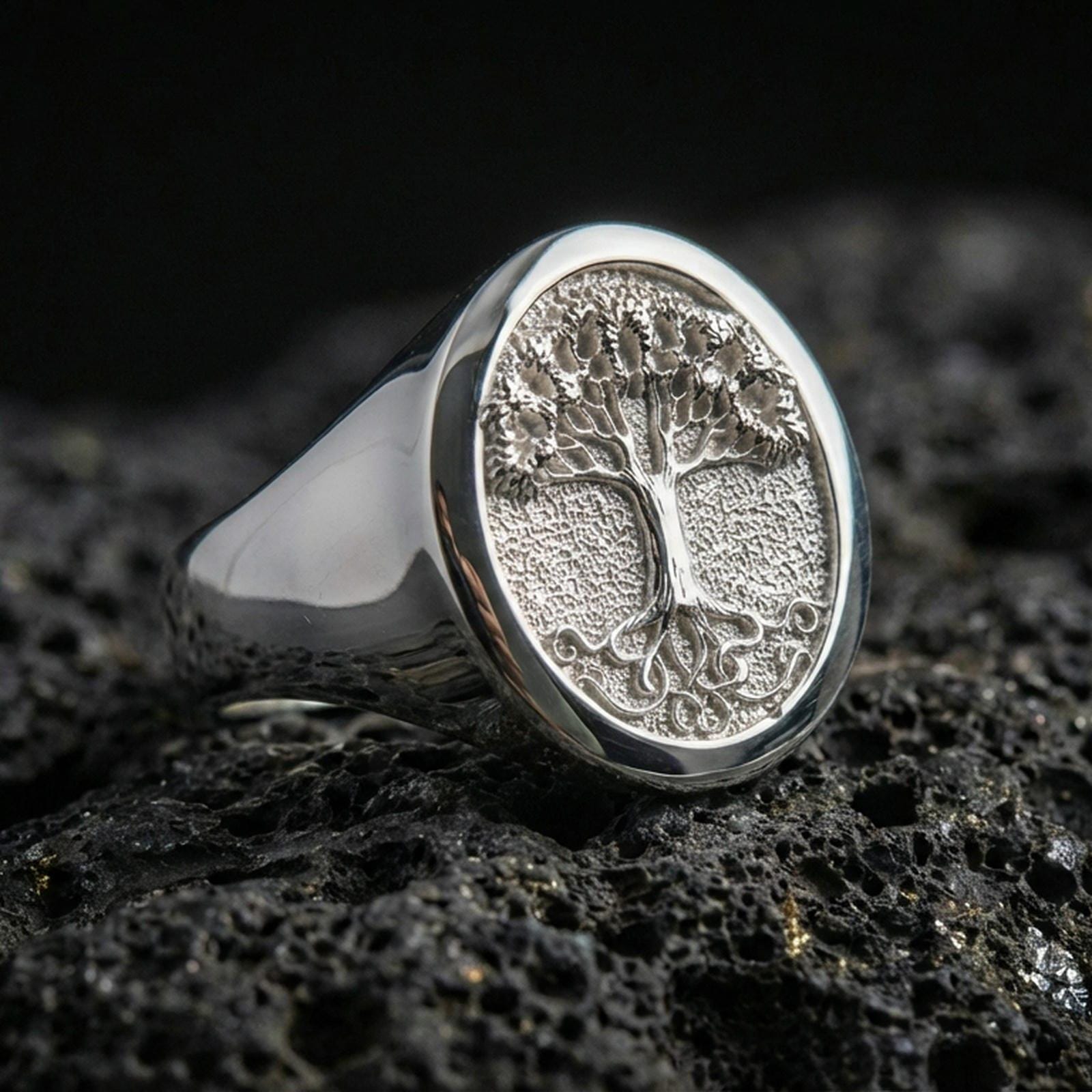 Yggdrasil Tree of Life ring in polished silver finish on volcanic rock, detailed roots and branches, premium product photo
