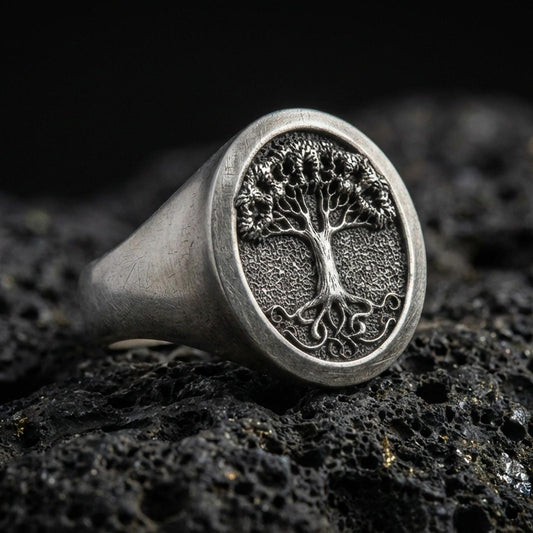 Sterling silver Tree of Life signet ring in oxidized finish on volcanic rock, Yggdrasil world tree, macro close-up