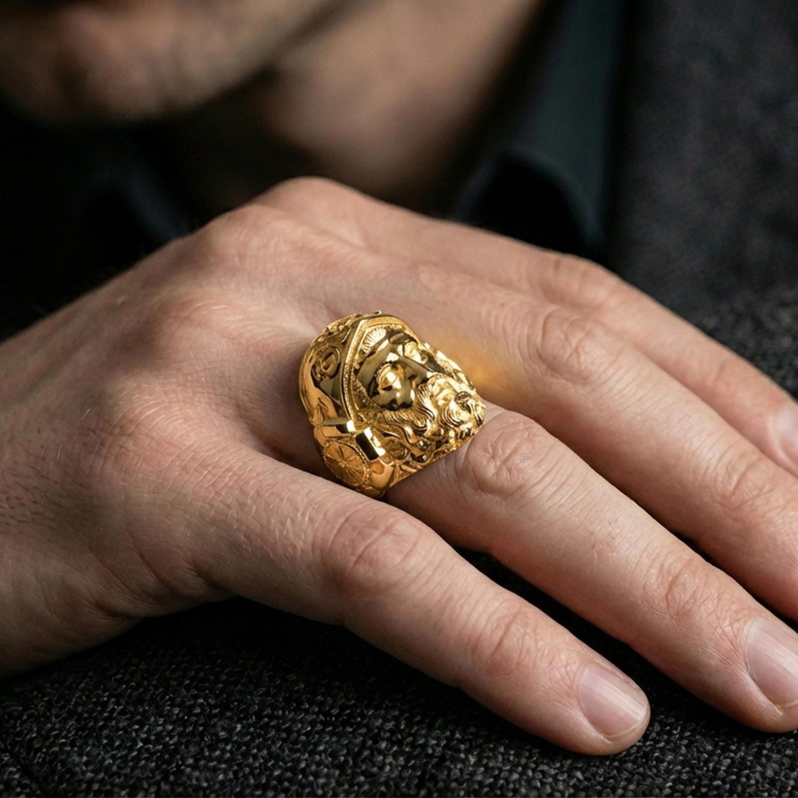 Gold plated Hephaestus signet ring worn on finger, statement mythology jewelry piece inspired by blacksmith and forge symbolism