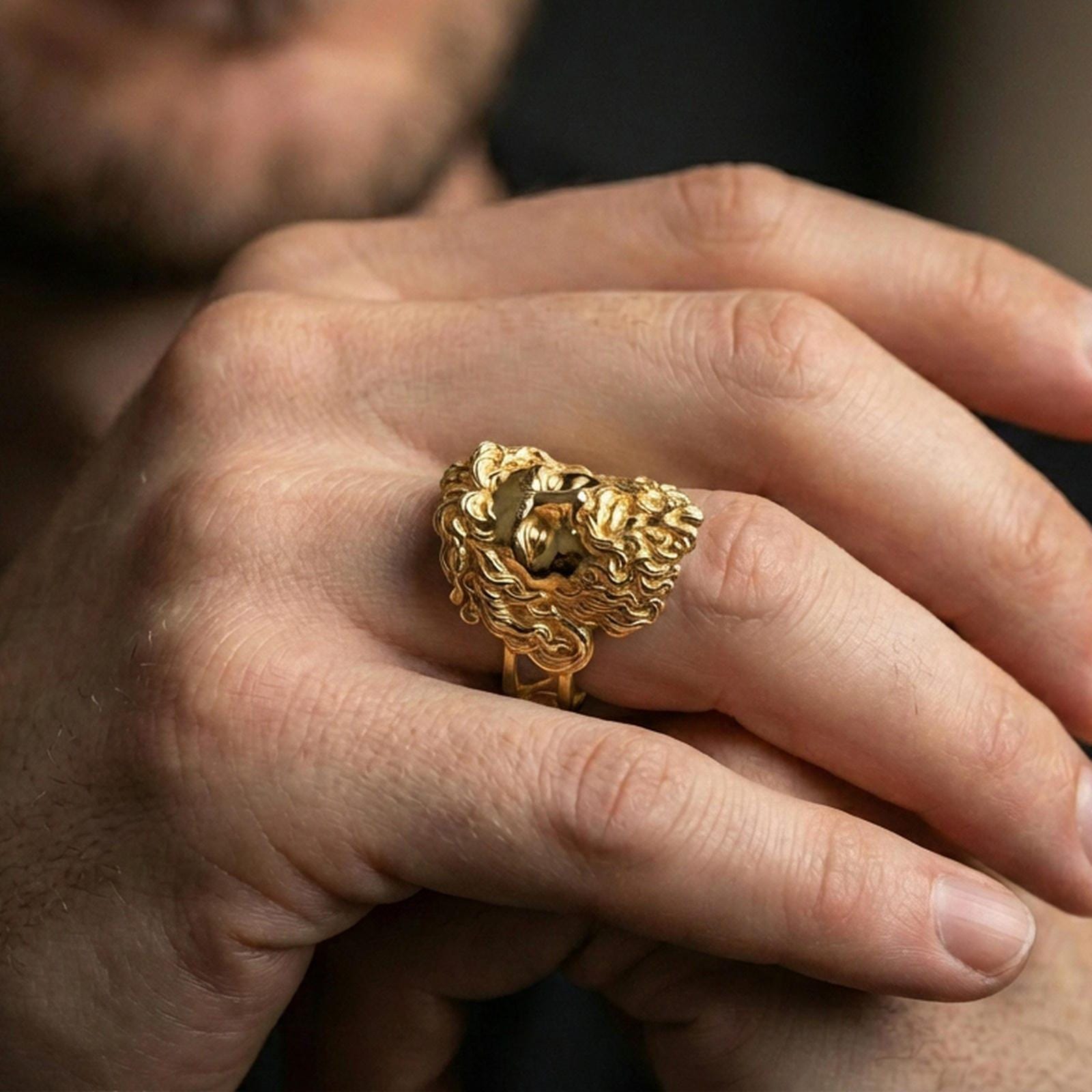 Gold plated Zeus mythology ring worn on finger, statement signet style inspired by ancient Greek gods, premium lifestyle close-up