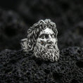 Load image into Gallery viewer, Polished silver Zeus ring with sculpted hair and beard details, centered close-up jewelry photo on dark porous volcanic stone
