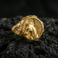 Load image into Gallery viewer, Gold plated Pegasus signet ring with high-relief mythical horse and feathered wings design, premium studio macro on black volcanic rock surface
