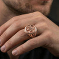 Load image into Gallery viewer, Rose gold plated griffon ring on finger featuring sculpted winged griffin emblem, refined fantasy jewelry lifestyle wear shot
