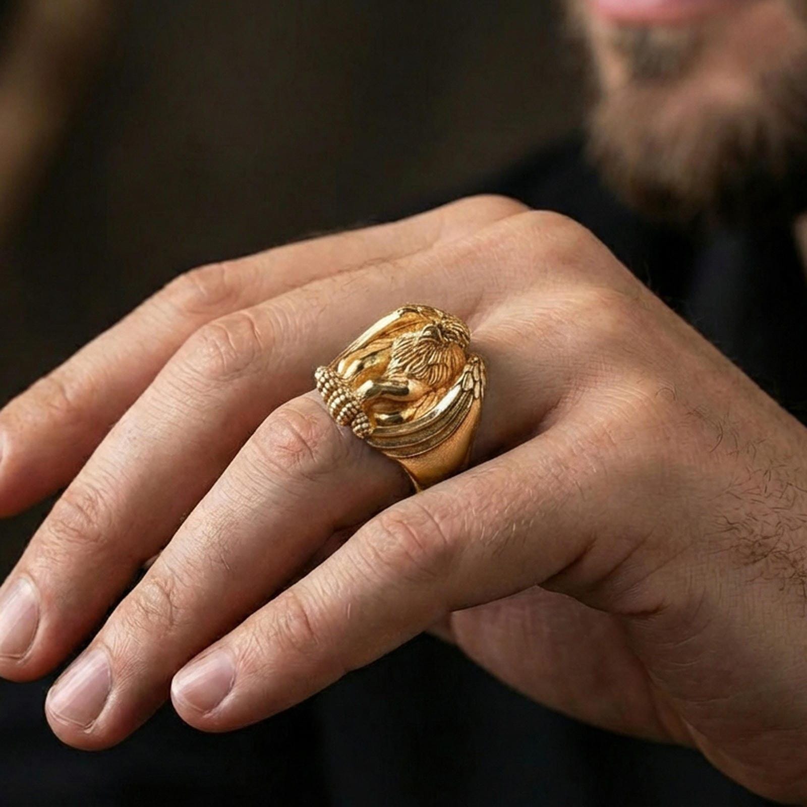 Gold plated griffin guardian ring worn on finger, statement mythology jewelry inspired by ancient traveler protection symbols, premium lifestyle close-up