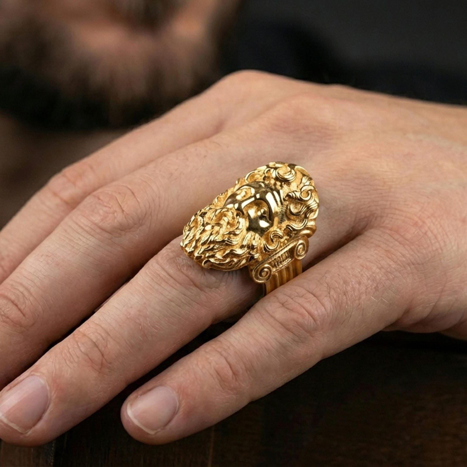 Gold plated Zeus signet ring worn on finger, statement mythology jewelry inspired by Jupiter and ancient Greek gods, premium lifestyle close-up
