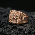 Load image into Gallery viewer, Rose gold plated gryphon ring showcasing detailed guardian beast emblem and radiating background texture, sharp close-up product photography on volcanic rock
