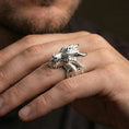 Load image into Gallery viewer, Polished silver dragon ring on finger highlighting detailed scales and fierce dragon expression, clean lifestyle wear photo
