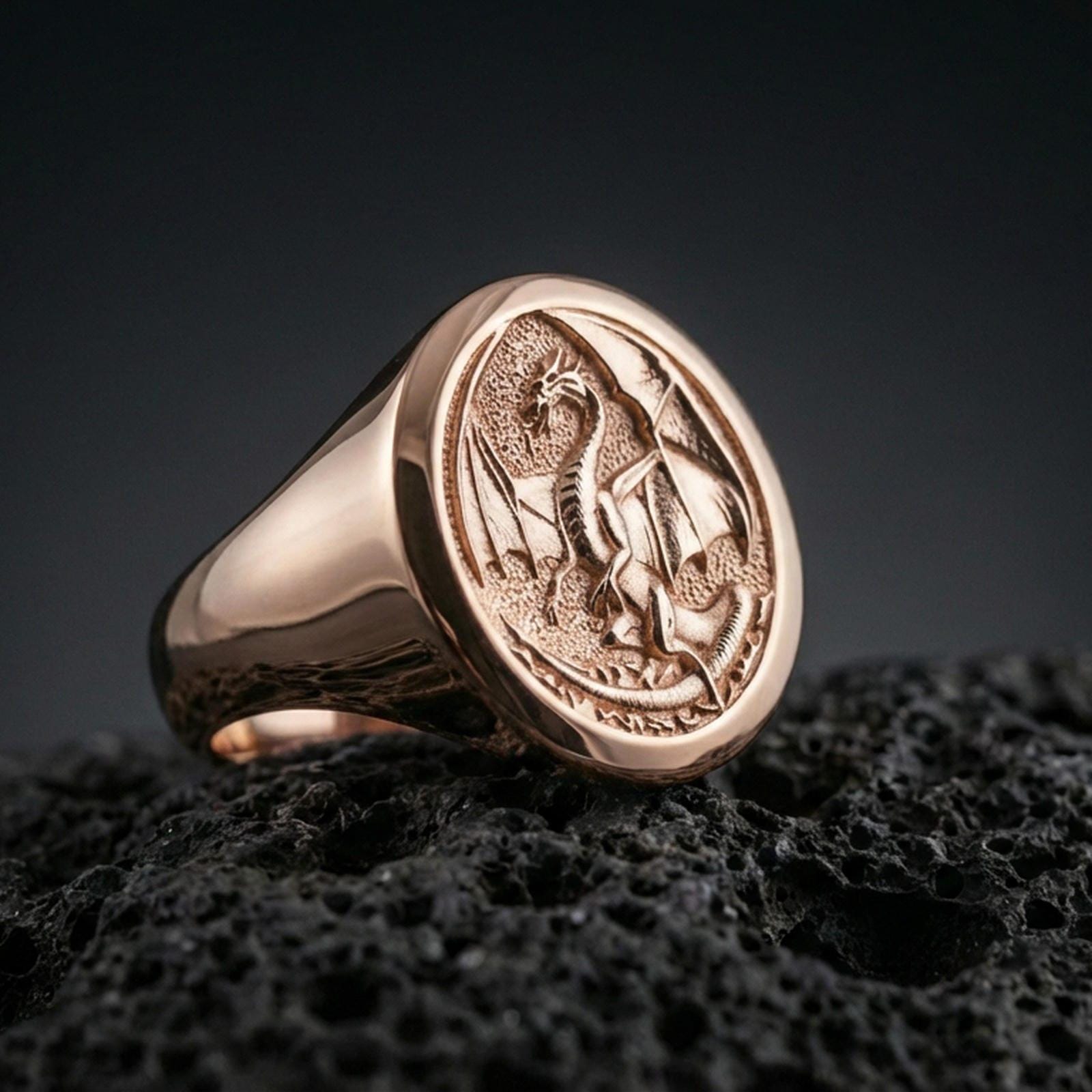 Rose gold plated Chinese dragon ring showcasing sculpted dragon figure and circular signet design, sharp close-up product photography on volcanic rock