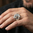 Load image into Gallery viewer, Polished silver werewolf ring on finger highlighting detailed wolf head sculpture and fierce expression, clean lifestyle wear photo
