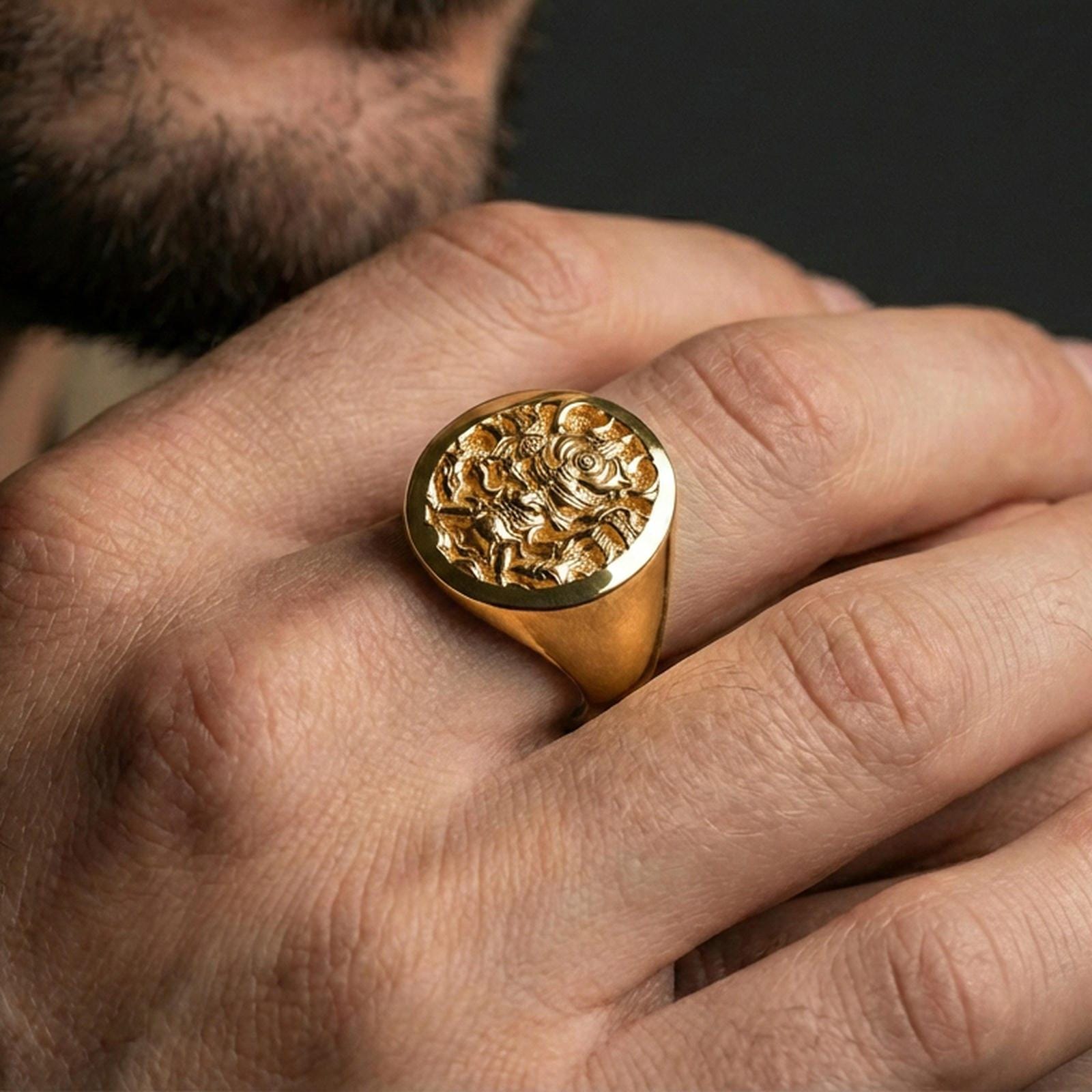 Gold plated samurai warrior ring on a human finger, Japanese warrior mask signet, fantasy-inspired statement jewelry