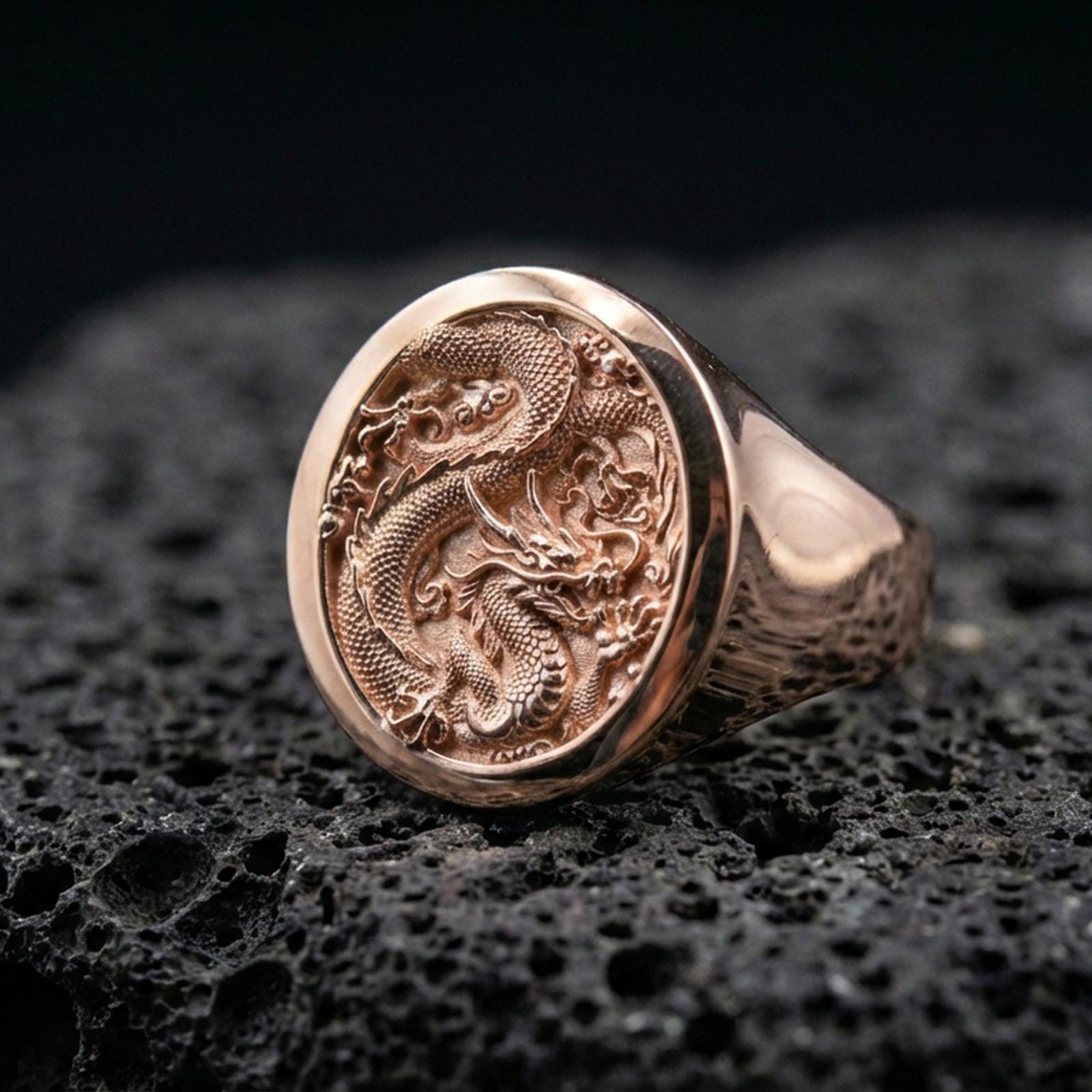 Rose gold plated Chinese dragon signet ring on black volcanic stone, coiled dragon emblem, Asian mythology signet ring