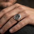 Load image into Gallery viewer, Oxidized sterling silver Chinese dragon signet ring on a human finger, coiled dragon relief, lucky guardian statement jewelry
