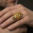 Load image into Gallery viewer, Gold plated lich skull ring worn on a human finger, fantasy wizard skull motif, statement ring
