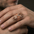 Load image into Gallery viewer, Rose gold plated lich skull ring on a human finger, gothic skull signet, dark fantasy aesthetic

