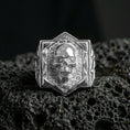 Load image into Gallery viewer, Polished sterling silver skull signet ring on black volcanic stone, raised skull face, brick wall engraving

