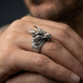 Load image into Gallery viewer, Oxidized sterling silver horned dragon ring worn on a human finger, detailed dragon head and horns, mythical statement ring
