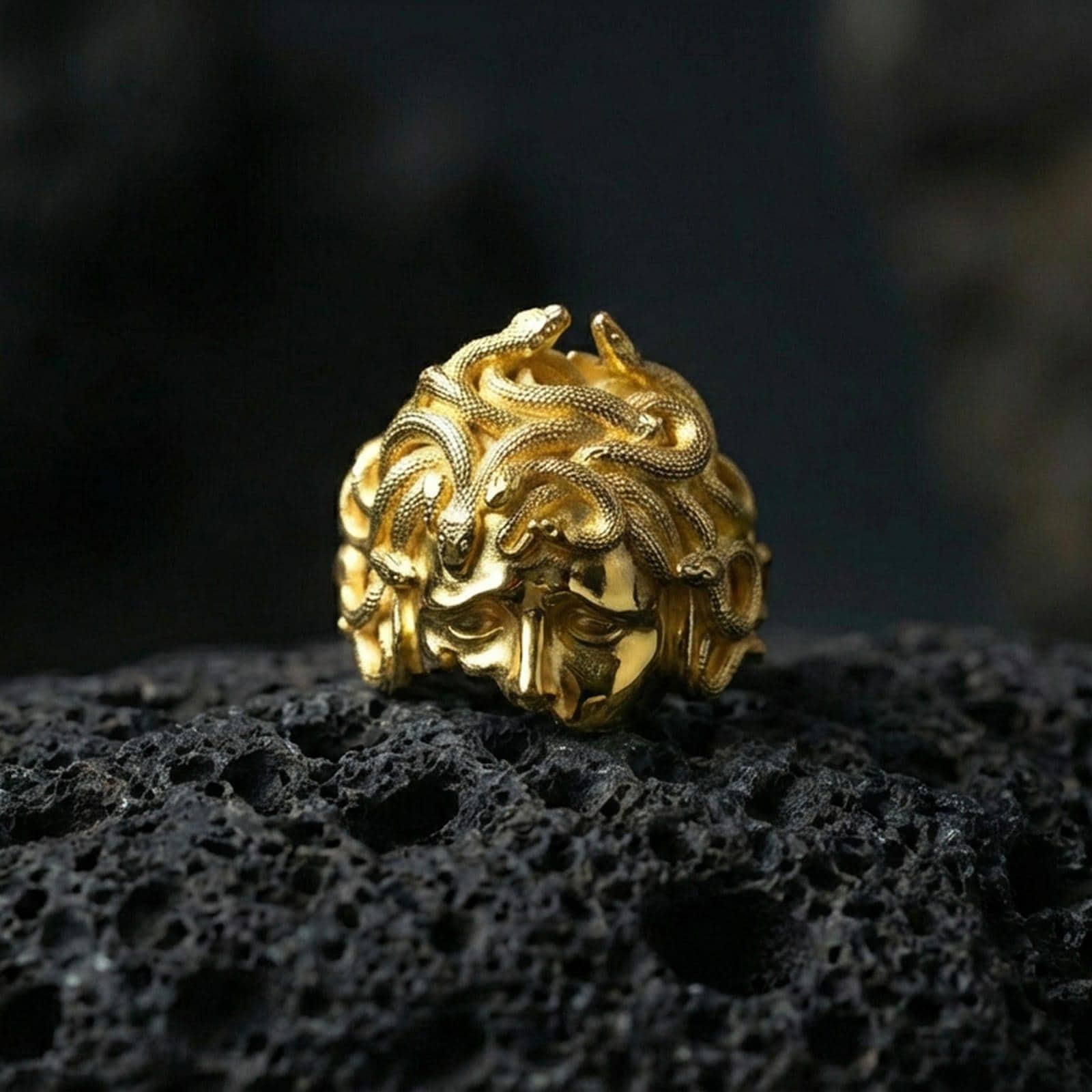 Gold plated Medusa gorgon head ring on black volcanic stone, snake hair relief signet, Greek goddess jewelry