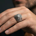 Load image into Gallery viewer, Oxidized biomechanical alien skull ring worn on a human finger, sci-fi gothic statement ring, xenomorph-inspired design
