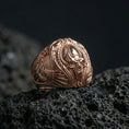 Load image into Gallery viewer, Rose gold plated alien skull ring on black volcanic stone, biomechanical gothic skull detailing, futuristic signet
