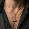Load image into Gallery viewer, Rose gold plated Viking labrys axe necklace pendant on a human neck, ornate Viking axe pendant, braided chain
