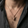Load image into Gallery viewer, Rose gold plated bull head necklace pendant on a human neck, Taurus zodiac horned bull charm, braided chain
