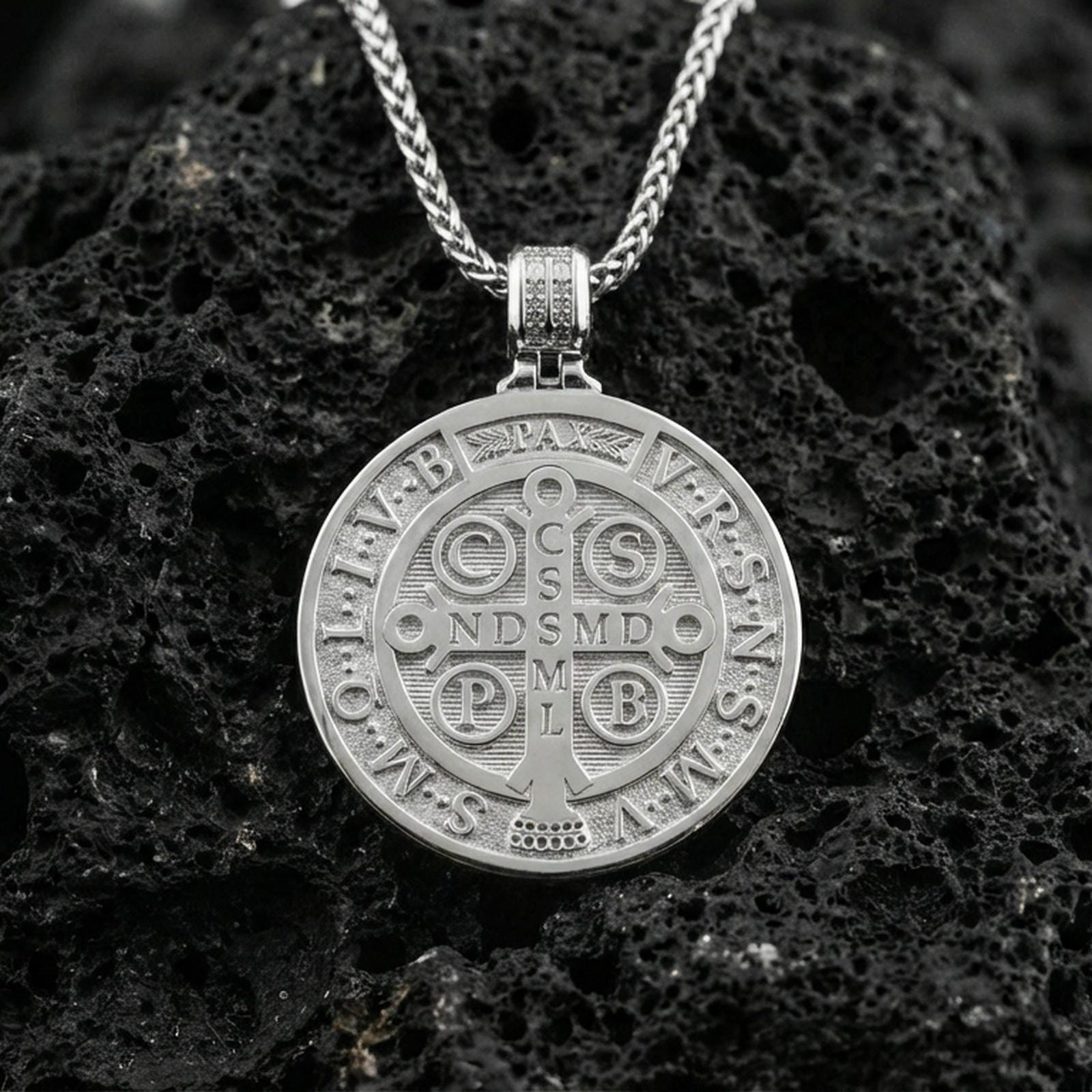 Polished sterling silver St. Benedict medal necklace on black volcanic stone, sacred Christian devotional pendant, braided chain