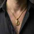 Load image into Gallery viewer, Gold plated memento mori pendant necklace worn on neck, premium lifestyle composition, coin-style medallion with split skull-face design
