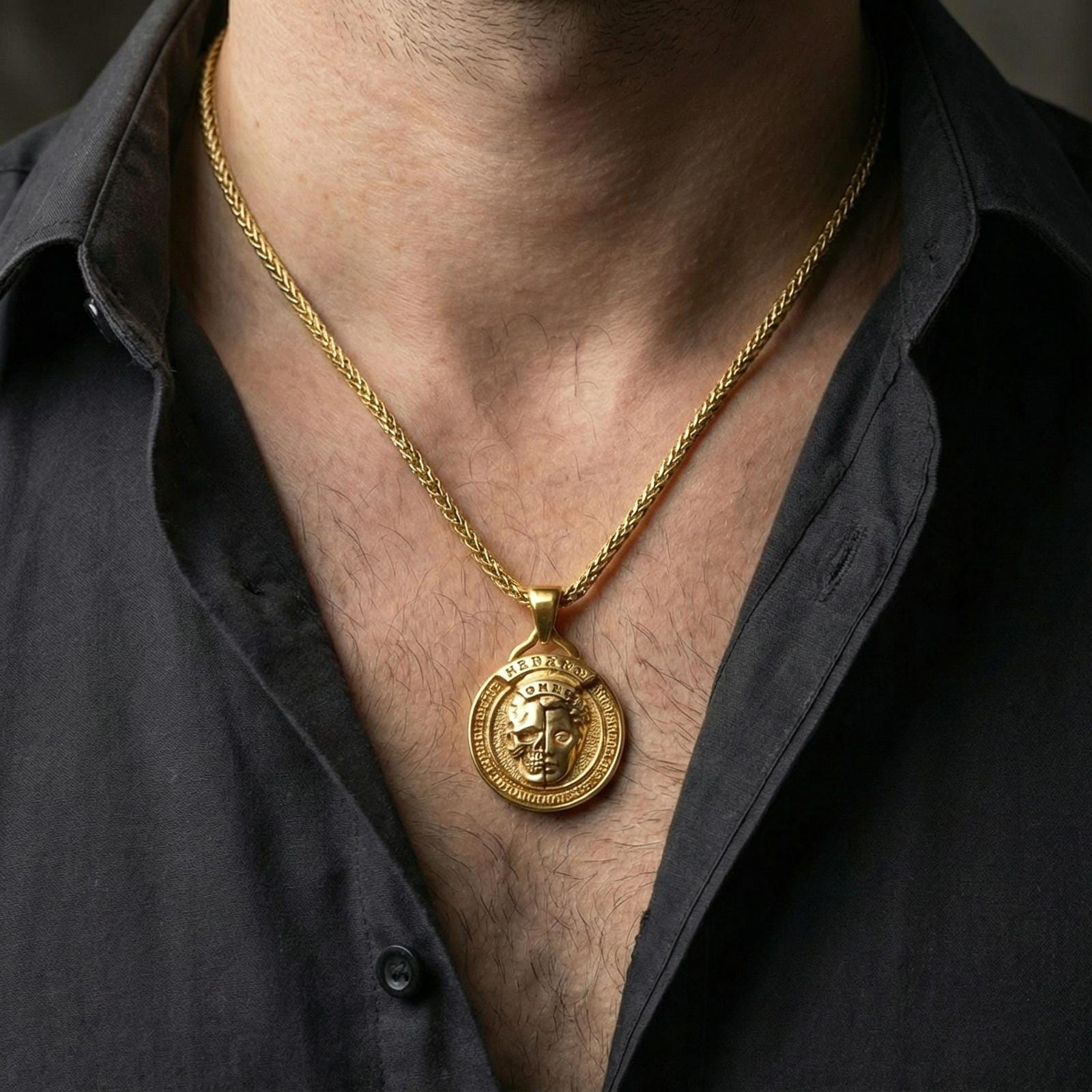 Gold plated memento mori pendant necklace worn on neck, premium lifestyle composition, coin-style medallion with split skull-face design