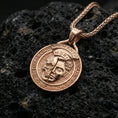 Load image into Gallery viewer, Rose gold plated memento mori coin pendant on porous volcanic rock, detailed relief and inscription ring, sharp macro focus
