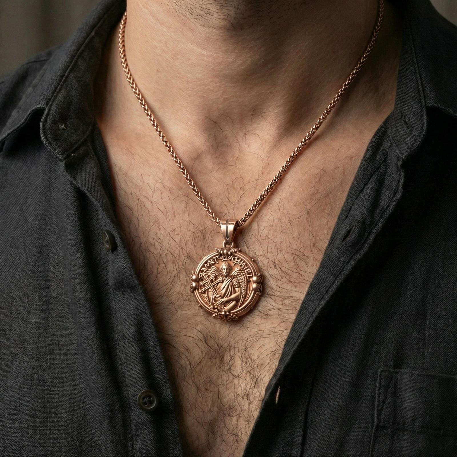 Rose gold plated Saint Gabriel coin pendant worn on neck, detailed archangel centerpiece, clean lifestyle framing with dark shirt contrast