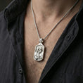 Load image into Gallery viewer, Polished silver Holy Family medal necklace worn on neck, close lifestyle crop, clear family relief and patterned background detail

