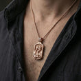 Load image into Gallery viewer, Rose gold plated Holy Family pendant worn on neck, detailed Mary Joseph and Child relief, clean lifestyle framing with dark shirt contrast
