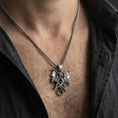 Load image into Gallery viewer, Oxidized sterling silver pentagram dragon pendant worn on neck on a braided chain, centered chest framing, moody lifestyle studio shot
