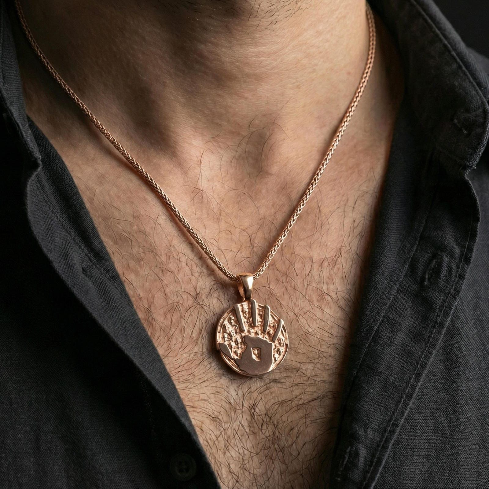Rose gold plated Dark Brotherhood pendant worn on neck, detailed handprint symbol and skull background, clean lifestyle framing with dark shirt contrast