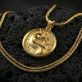 Load image into Gallery viewer, Gold plated Mortal Kombat dragon pendant on dark volcanic rock, round gamer medallion with bold dragon symbol, premium macro detail
