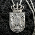 Load image into Gallery viewer, Polished silver Serbia coat of arms pendant on volcanic rock, crisp double eagle crest with national shield detail
