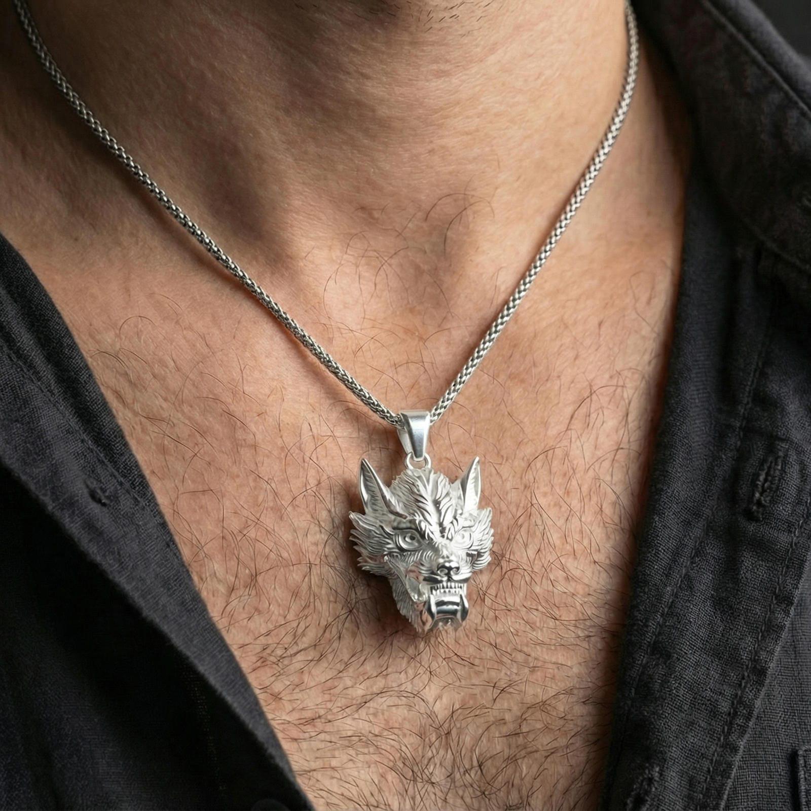 Polished silver Chinese dragon head necklace worn on neck, fierce dragon face pendant centered, clean lifestyle crop