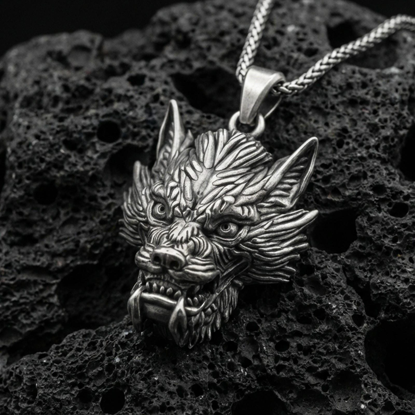 Oxidized sterling silver Chinese dragon head pendant on volcanic rock, detailed mythical dragon face necklace, macro close-up