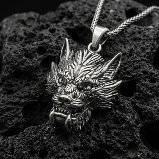 Oxidized sterling silver Chinese dragon head pendant on volcanic rock, detailed mythical dragon face necklace, macro close-up