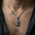 Load image into Gallery viewer, Oxidized sterling silver Fortuna goddess pendant worn on neck, Roman luck deity necklace on braided chain, lifestyle close-up
