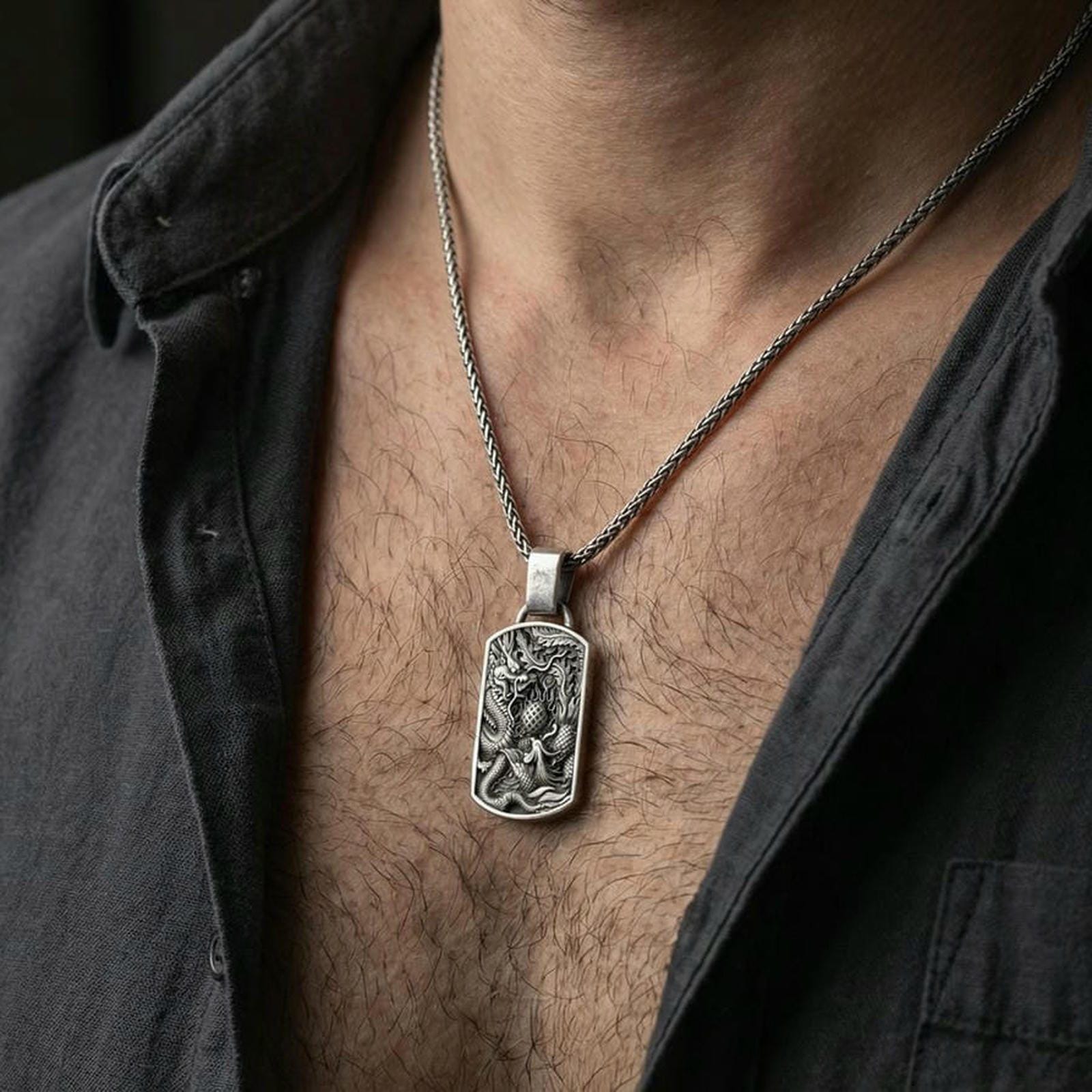 Oxidized sterling silver dragon and phoenix pendant worn on neck, yin yang symbol necklace on braided chain, lifestyle crop