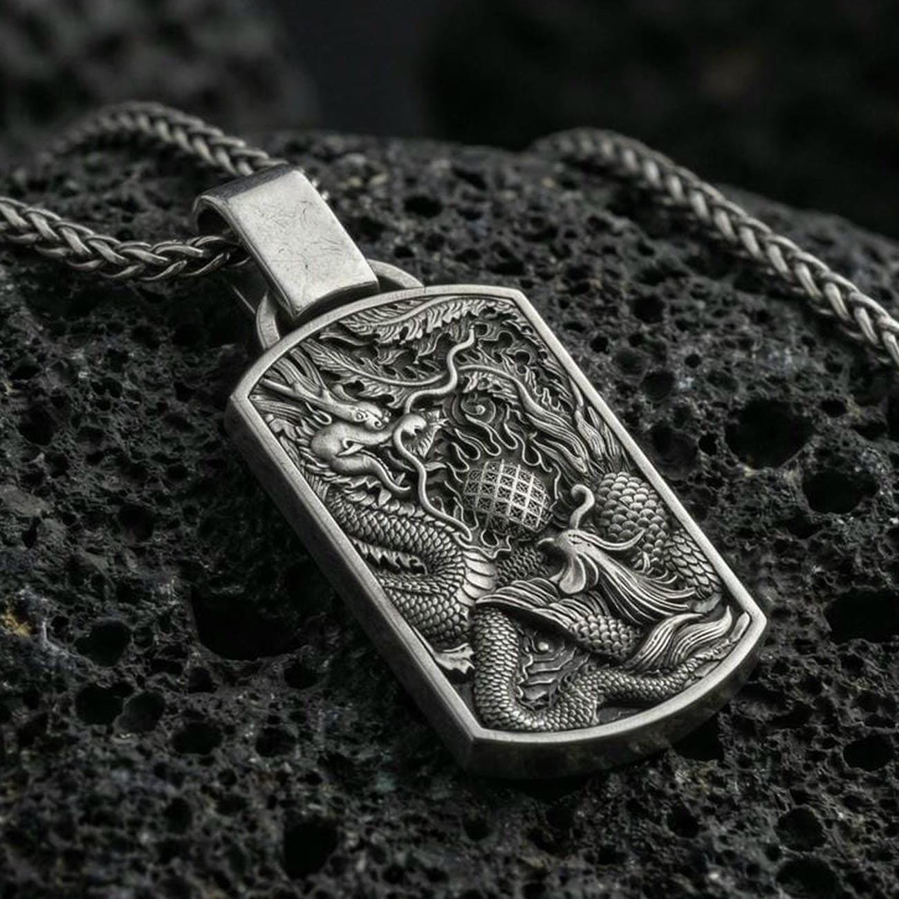 Oxidized sterling silver dragon and phoenix pendant on volcanic rock, yin yang harmony necklace, macro detail