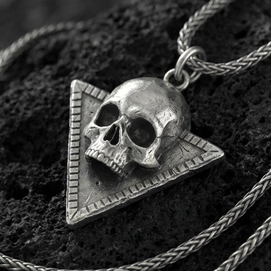 Oxidized sterling silver Absolute’s talisman skull pendant on volcanic rock, Baldur’s Gate 3 cult amulet, macro close-up