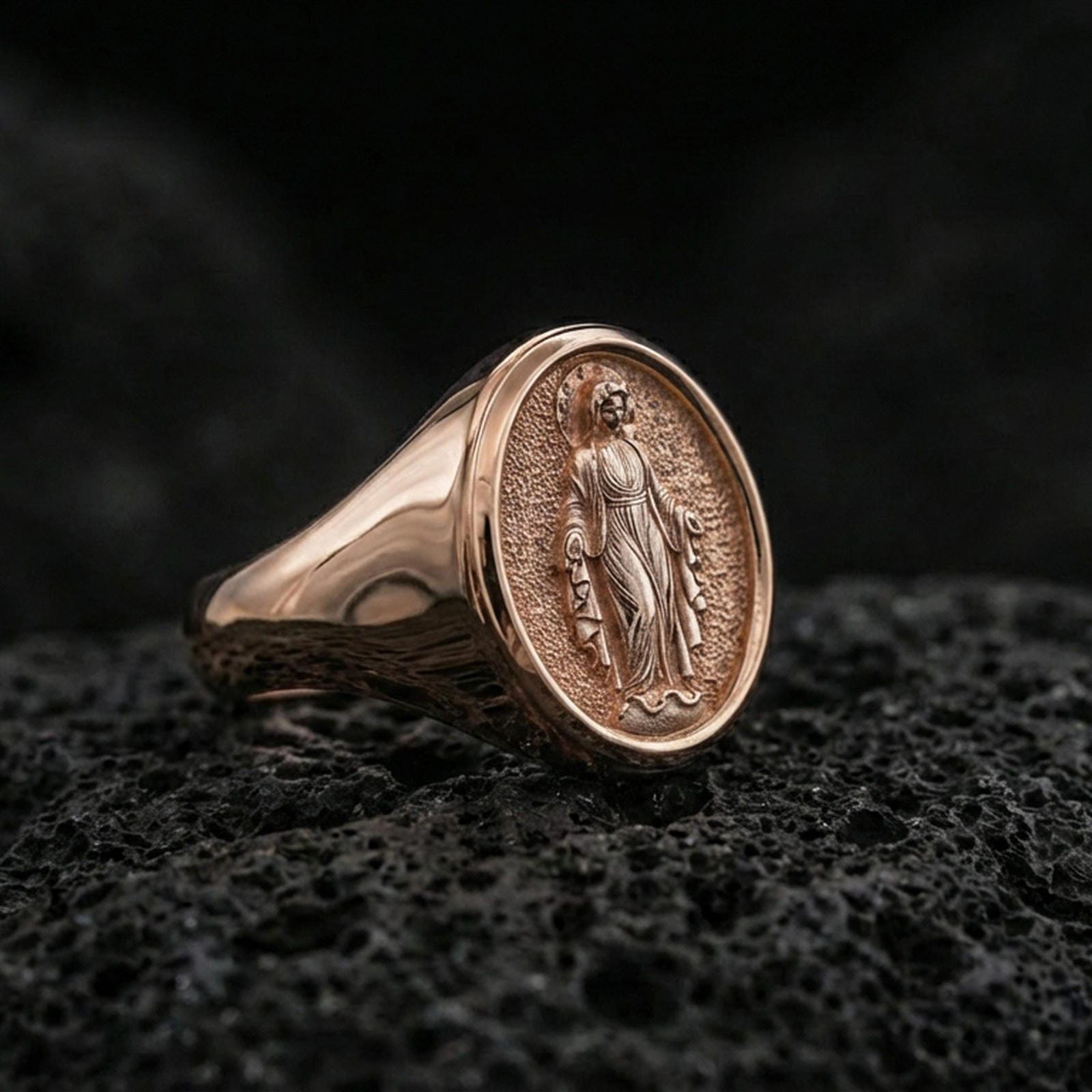 Rose gold plated Virgin Mary oval signet ring on volcanic stone, Marian devotional jewelry, premium macro lighting